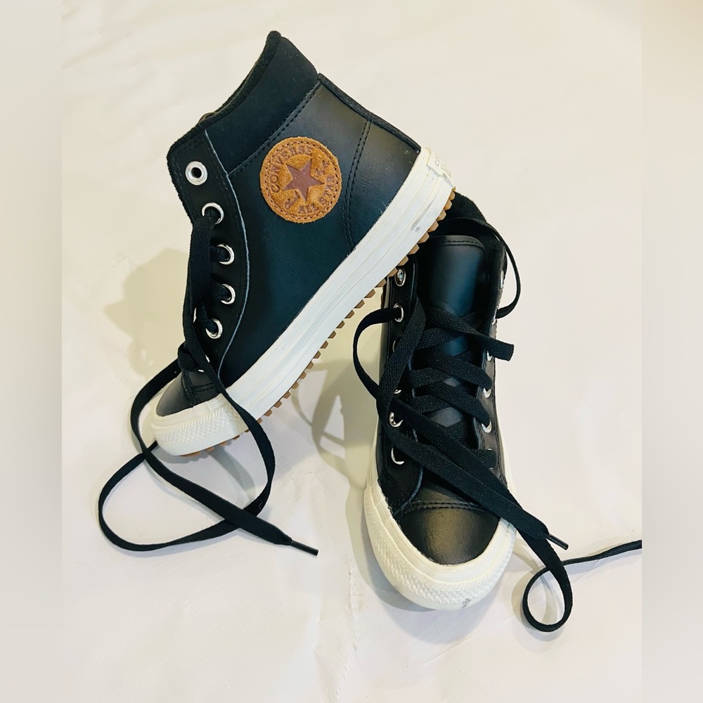 Converse black leather chuck Taylor’s. With brown circle chuck taylor patch